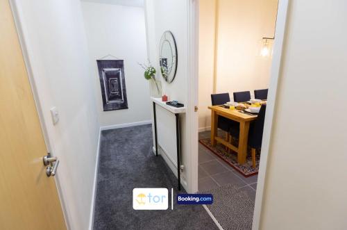 an open door to a room with a table at 2 Bedroom Apartment By The One Retreats Short Lets & Serviced Accommodation Horley Close To Gatwick Airport in Horley