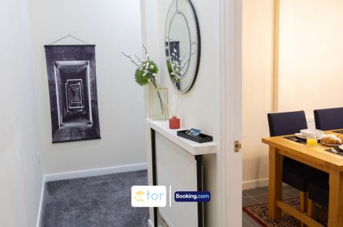 a room with a table and a mirror on the wall at 2 Bedroom Apartment By The One Retreats Short Lets & Serviced Accommodation Horley Close To Gatwick Airport in Horley