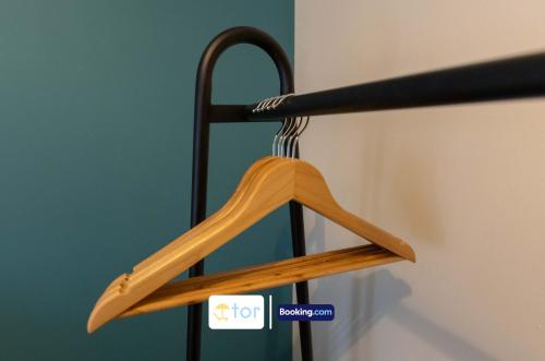 a wooden hanger is hanging on a rail at 2 Bedroom Apartment By The One Retreats Short Lets & Serviced Accommodation Horley Close To Gatwick Airport in Horley