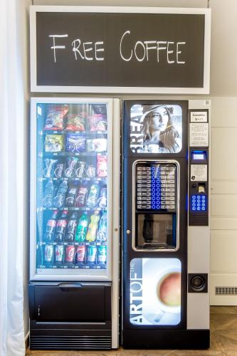 a free coffee vending machine with a free coffee sign at WH Apartments in Ljubljana