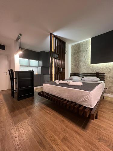 a bedroom with a large bed and a table at LiboroPlanet in Niš