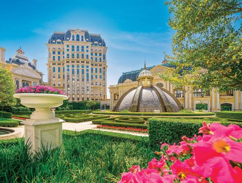 a garden with flowers in front of a building at Grand Lisboa Palace Macau in Macau