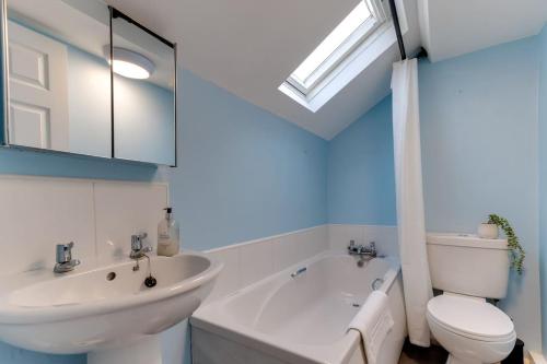 a bathroom with a sink and a toilet and a bath tub at Lavender Cottage - a beautiful quirky family cottage in Snainton