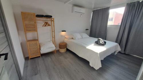 a bedroom with a bed with a backpack on it at Topdown Apartments in Hospitalet de Llobregat