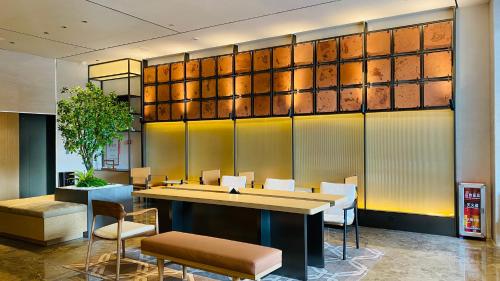 a conference room with a table and chairs at Puji Hotel in Guangzhou