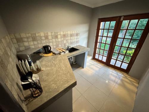 a kitchen with a sink and a counter top at Nectar Game Lodge in Buffelspoort