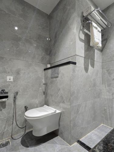 a bathroom with a toilet and a shower at Clarks Inn Suites Agra Near Tajmahal in Agra