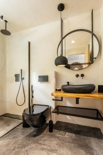 a bathroom with a tub sink and a mirror at Noma Beach Resort in Chernomorets