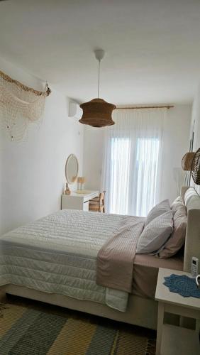 a bedroom with a large bed and a window at Monte View Apartments in Ulcinj