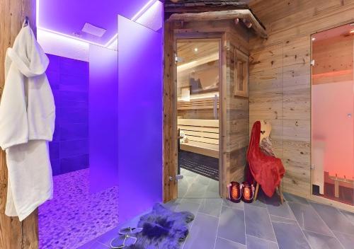 a bathroom with purple lighting and a walk in shower at Appartments Radauerhof in Castelrotto