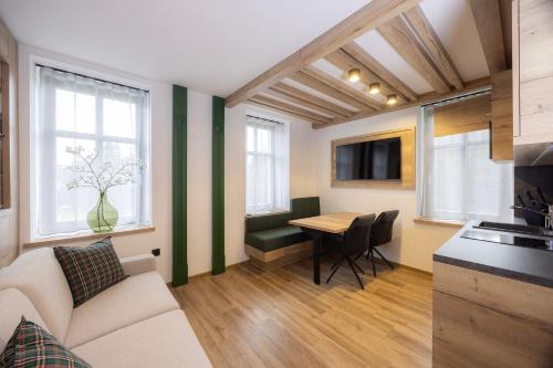 a living room with a couch and a table at Vila Savica Bled in Bled