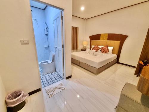 a hotel room with a bed and a bathroom at Lipe Urban Homestay in Ko Lipe