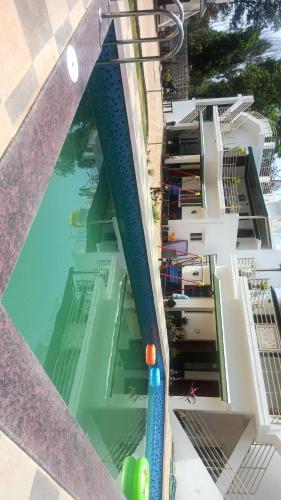 an overhead view of a swimming pool in a building at Rithu's Inn in Yelagiri