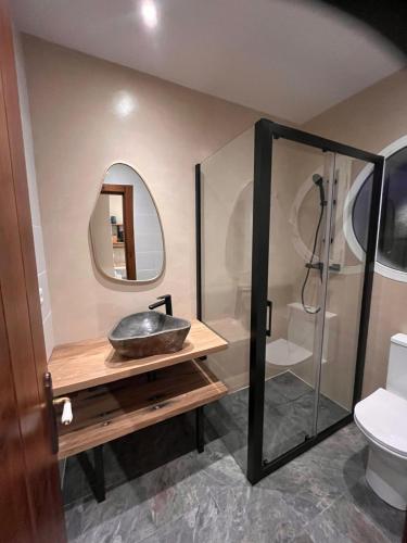 a bathroom with a sink and a shower at Casa de los Sueños in Coín