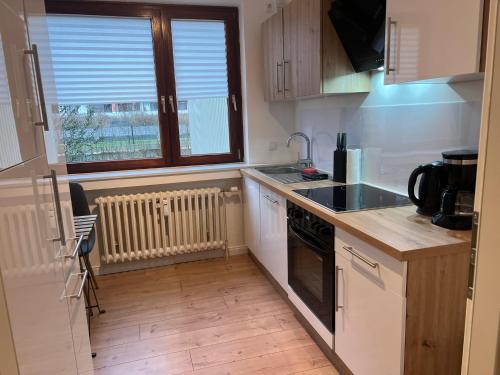 a kitchen with a sink and a stove at Wohnung Leverkusen I Garage I 4 Schlafzimmer in Leverkusen