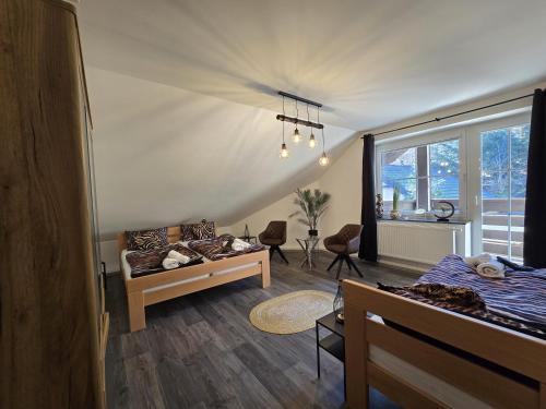 a room with two beds and a window at Fleiš Residence in Most