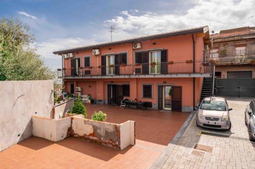 a house with a car parked in front of it at Villa Graziella in Tremestieri Etneo