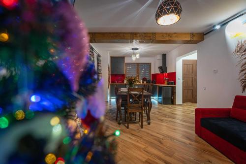 a living room with a christmas tree in the foreground at Domki Bukowianka in Murzasichle