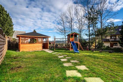 a playground with a gazebo and a slide at Domki Bukowianka in Murzasichle
