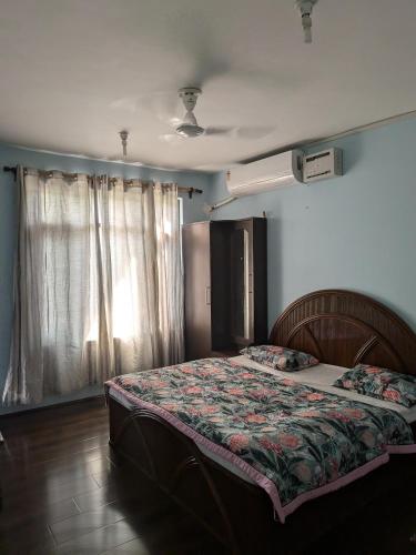 a bedroom with a bed and a window at John's palace in Srinagar