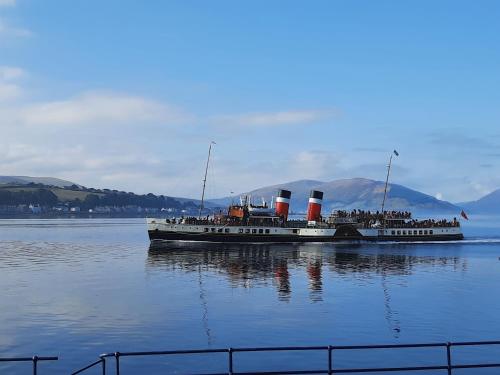 a large boat floating on a large body of water at Highlander House Boutique Hotel in Rothesay