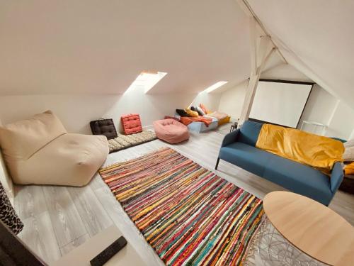 un salon avec un canapé et un tapis dans l'établissement Belle appartement 4 chambres, à Reims