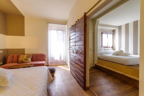 a bedroom with a bed and a large wooden wall at Aurora Boutique Hotel & Private SPA in Spoleto