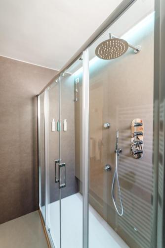 a shower with a glass door in a bathroom at Aurora Boutique Hotel & Private SPA in Spoleto