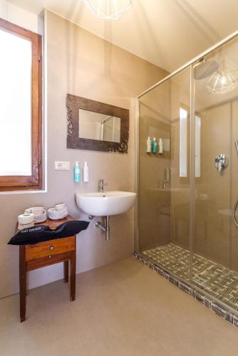 a bathroom with a sink and a shower at Aurora Boutique Hotel & Private SPA in Spoleto