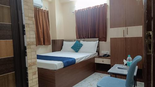 a small room with a bed and a table at Fab international hotel in Beliaghata