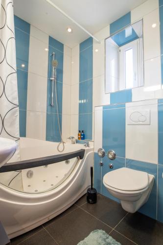 a bathroom with a bath tub and a toilet at Special ROGER F RABBIT 2 Apartment, Roche Towers, 10-STAR in Basel