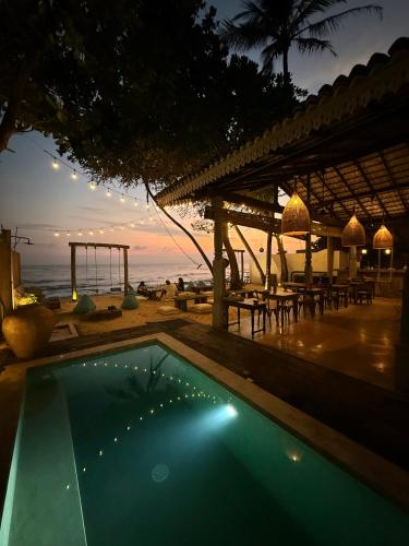 a swimming pool at a resort with a view of the ocean at Moi Talpe by DBI in Talpe