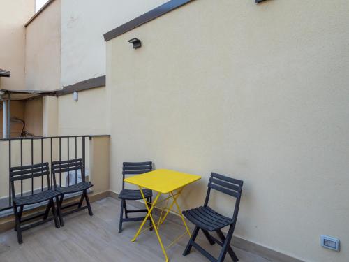 a yellow table and chairs on a balcony at Luxury apartment - Flumendosa 5 in Milan