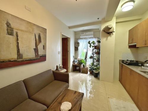 a living room with a couch and a kitchen at Centrally Located Affordable Apartment with Kitchen in Boracay