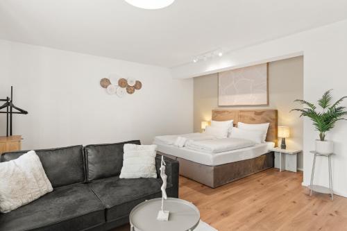 a living room with a couch and a bed at YUVA HOMES in Untermeitingen in Untermeitingen