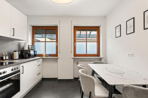 a kitchen with a table and a dining room at YUVA HOMES in Untermeitingen in Untermeitingen