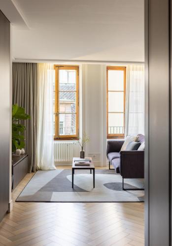 a living room with a couch and a table at The Hamlet - Luxury Serviced Apartments in Geneva