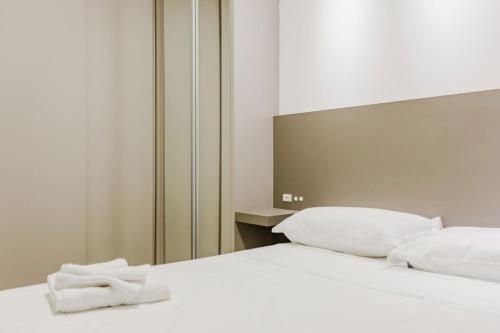 a white bed with a towel on top of it at Alto Padrão em Itapema, 8min a pé até o Mar FN8750 in Itapema