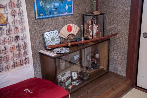 a room with a shelf with items on it at Benton Guesthouse, Private Nostalgic Showa-era House, former "Akiya" in Imabari