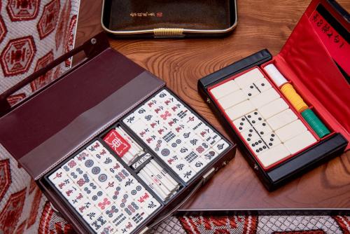 a wooden table with a calendar and a cell phone at Benton Guesthouse, Private Nostalgic Showa-era House, former "Akiya" in Imabari