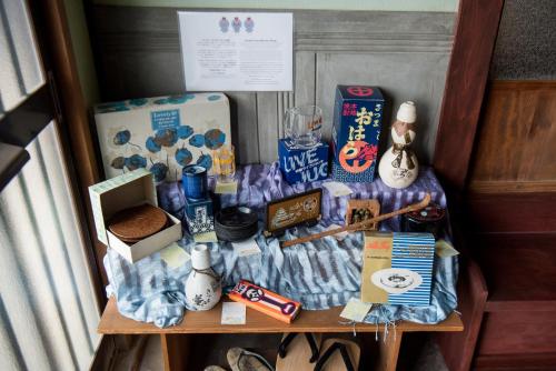 a table with a bunch of items on it at Benton Guesthouse, Private Nostalgic Showa-era House, former "Akiya" in Imabari