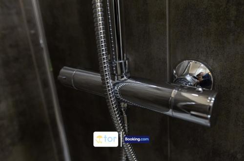 a metal door handle with a hose attached to it at 2 Bedroom Apartment By The One Retreats Short Lets & Serviced Accommodation Horley Close To Gatwick Airport in Horley