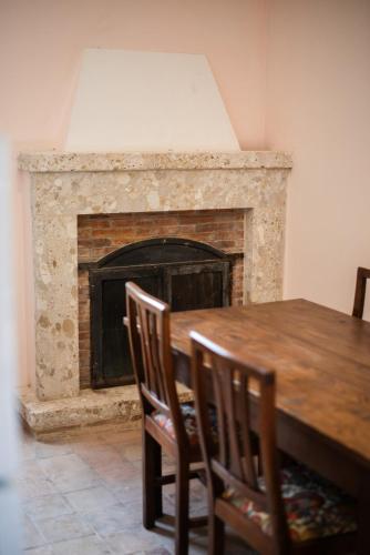 a dining room with a table and a fireplace at Casa Ciclope in Arpino
