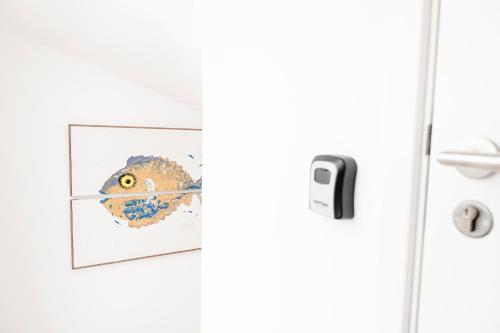 a door with a picture of a fish on it at Pedra do Mar in São Roque