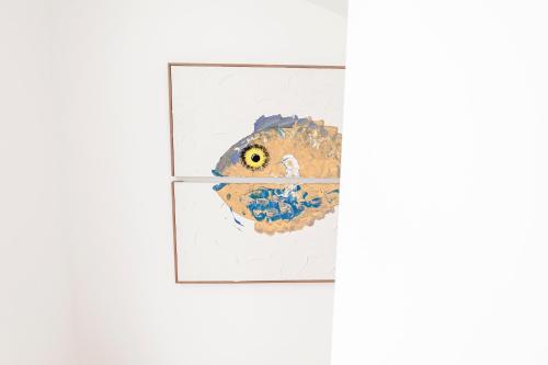 a painting of a bird on a picture frame on a wall at Pedra do Mar in São Roque