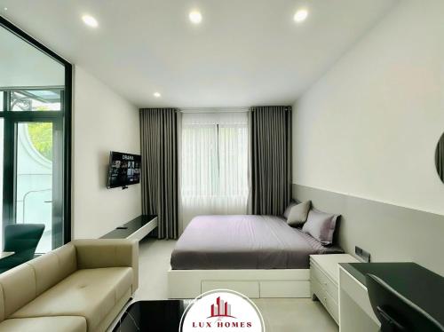 a small bedroom with a bed and a couch at The LuxHomes Apartment ᵀᴹ I HOT Độc Đáo Nhất Vinhomes Marina in Hai Phong