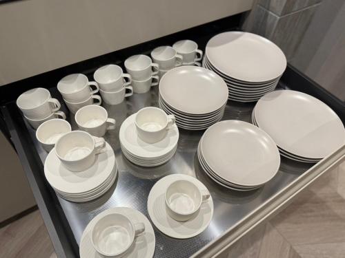 a bunch of white plates and cups on a tray at yado taniguchi in Matsuzaka