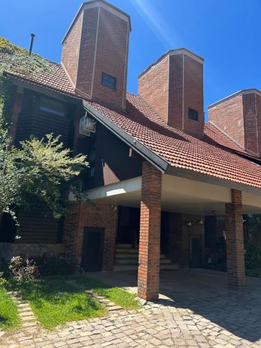 an old brick house with a red roof at Melhor sobrado de Gramado 600m da Rua Coberta in Gramado