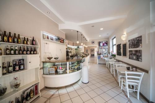 a restaurant with a bar with bottles of wine at Risorgimento - Albergo - Bar in Morciano di Romagna
