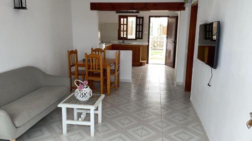 a living room with a couch and a table at Casa Elenita in La Oliva
